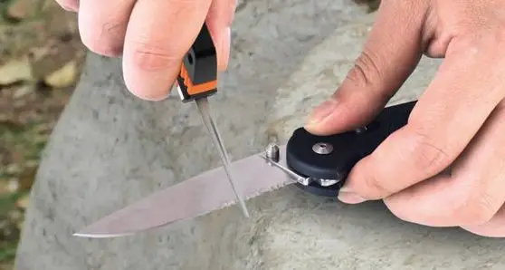 a man sharpening his pocket knife with a sharpner